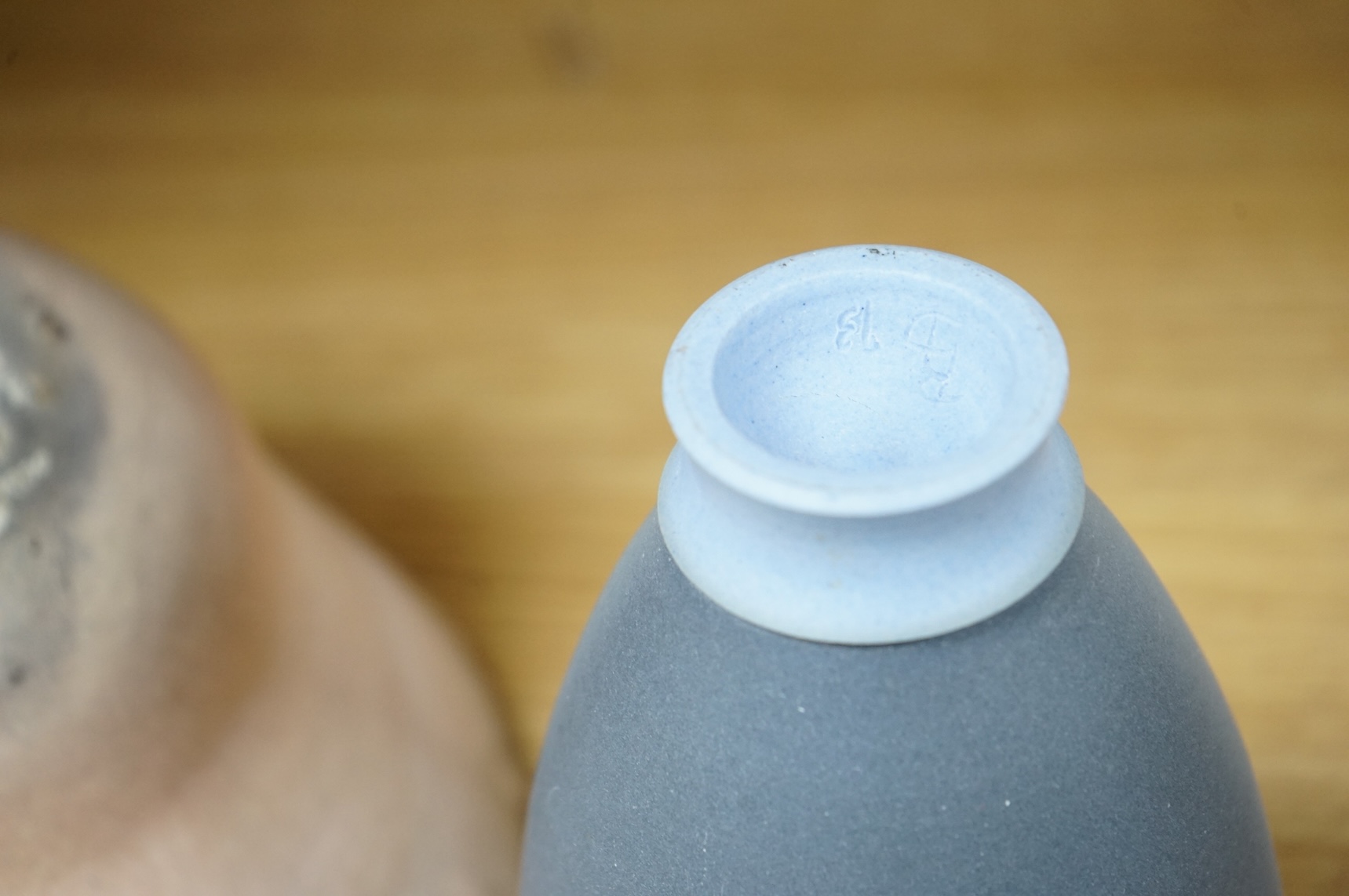 A studio pottery with incised initialled, dated ‘73 and a similar bowl, largest 21cm in diameter